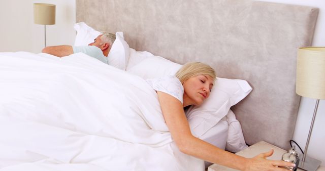 Senior Couple Sleeping Peacefully as Alarm Clock Rings - Download Free Stock Images Pikwizard.com