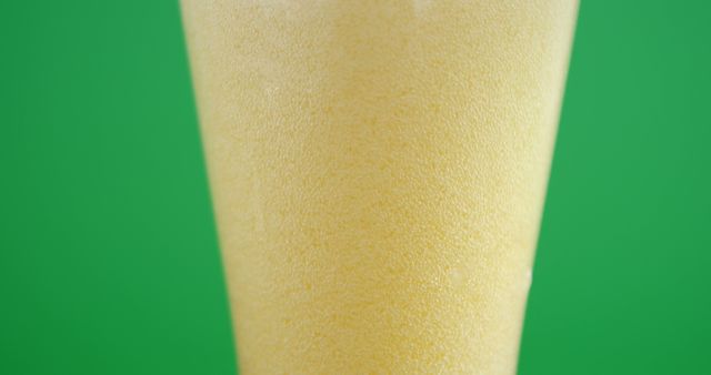 Closeup of Refreshing Cold Beer Foam Against Green Background - Download Free Stock Images Pikwizard.com