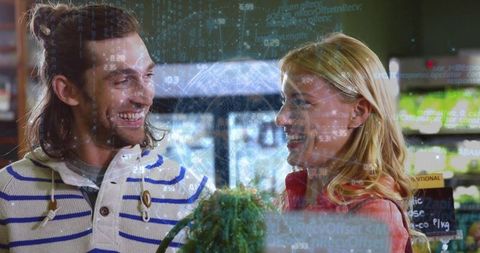 Smiling couple shopping fresh herbs with augmented reality data overlay at market