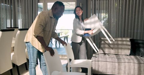 Therapist and client collaborating to prepare group therapy space