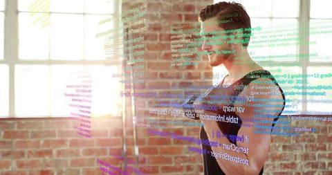 Male developer interacting with holographic code in sunlit industrial loft workspace