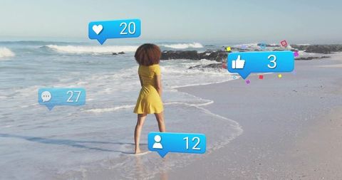Solitary woman on beach with interactive social media elements