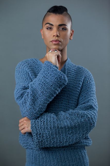 Confident Transgender Woman in Blue Sweater Posing Thoughtfully - Download Free Stock Photos Pikwizard.com
