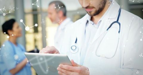 Doctor reviewing tablet with nurse in background and digital medical data overlay