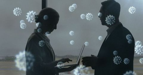 Business professionals discussion with digital virus overlay