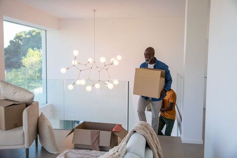 African American Father and Son Moving Entering Modern Home