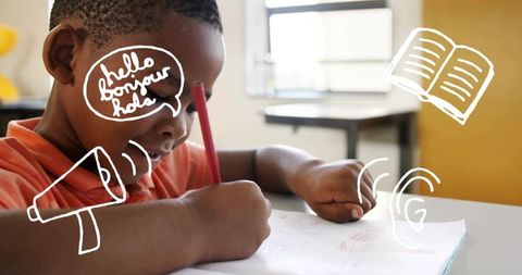 Focused young boy sketching with red pencil in bright classroom, creativity and learning