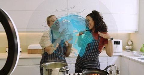 Holographic cooking collaboration: two women sharing world recipes in modern kitchen