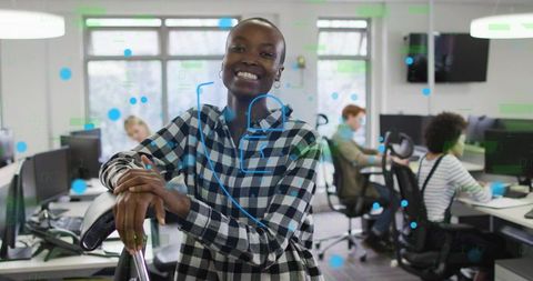 Black woman smiling, leaning on chair in modern open office with digital data overlay