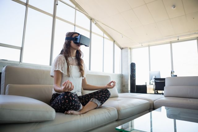 Businesswoman mediating while using virtual reality simulator in office