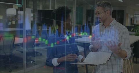 Colleagues reviewing candlestick chart and notebook, discussing fintech analytics
