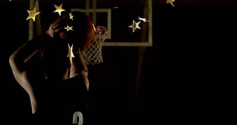 Basketball player preparing shot surrounded by gold stars