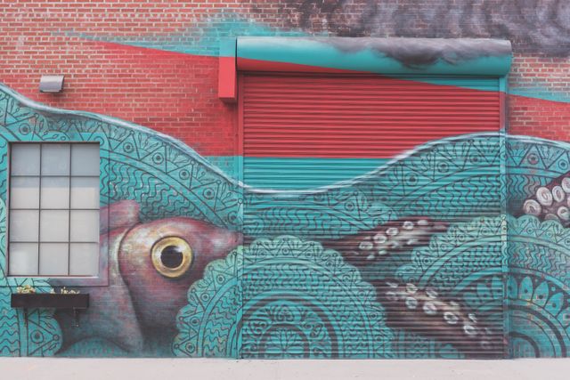 Vibrant Street Art on Urban Brick Wall with Geometric Designs and Fish - Download Free Stock Photos Pikwizard.com