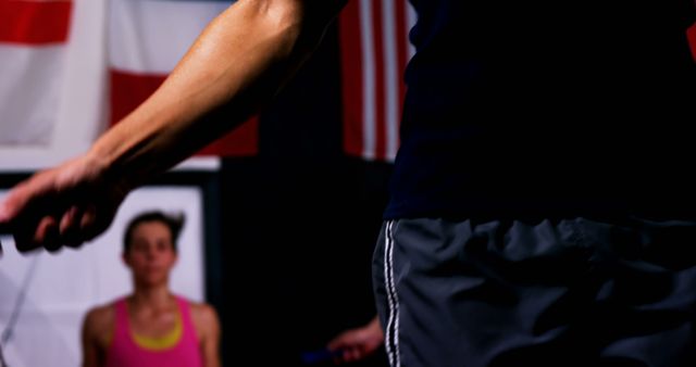 Boxer warming up using a skipping rope preps body for training. Image highlights the determination and intensity in his workout regime. Suitable for fitness articles, training guides, promotional materials for gyms or sports equipment, and motivational content related to athletic endurance and preparation.