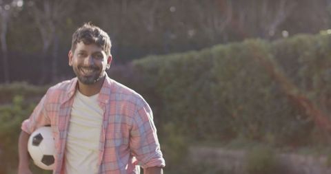 Active Indian Man Enjoying Sunny Day with Soccer Ball