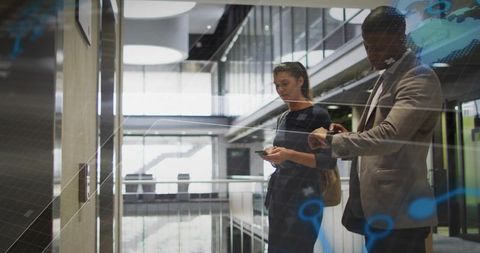 Business Professionals Using Smart Technology in Modern Office