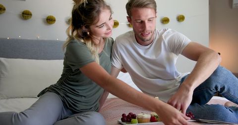 Couple Celebrating Birthday with Cupcakes at Home
