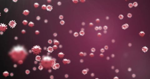 Macro View of COVID-19 Cells Against Red Background