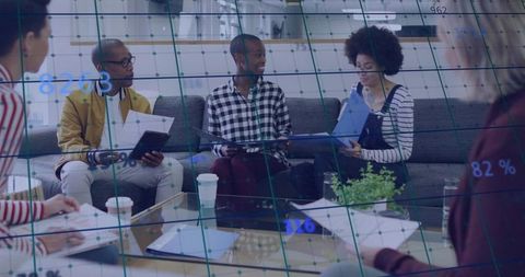 Diverse team brainstorming and collaborating in modern office with ar data overlay