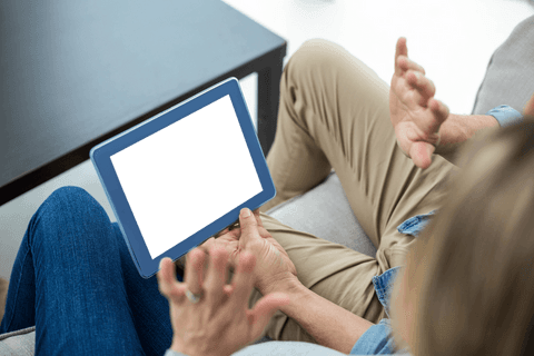 couple discussing with transparent tablet on couch relaxing - Download Free Stock Videos Pikwizard.com