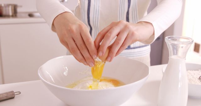 Person Cracking Egg into Mixing Bowl for Baking - Download Free Stock Images Pikwizard.com