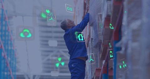 Warehouse worker reaching pallet rack with digital inventory icons for smart logistics