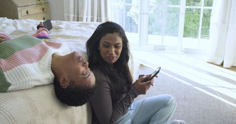 Diverse Female Friends Enjoying Leisure Time with Smartphones