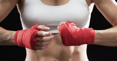 Boxer Wrapping Hands in Red Starting Training