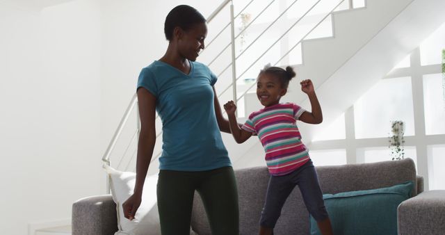 Active Mother and Daughter Dancing Together at Home - Download Free Stock Images Pikwizard.com