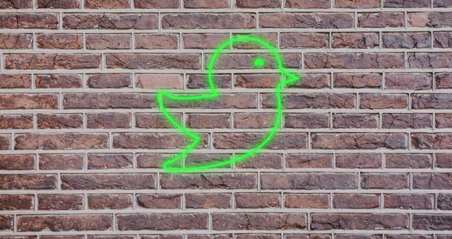 Green Glowing Bird Icon on Brick Wall, Twitter Representation - Download Free Stock Images Pikwizard.com