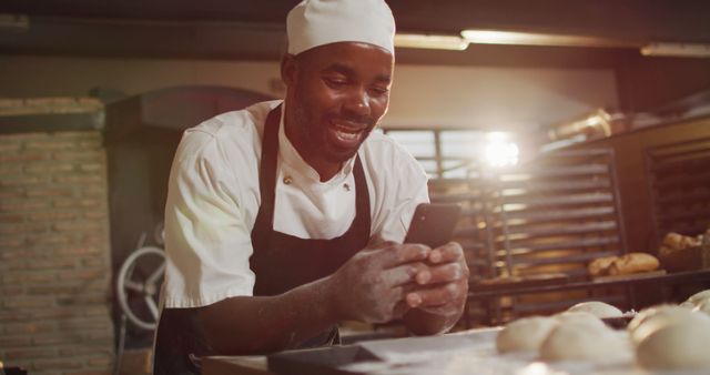 Smiling African Chef Using Smartphone in Bakery - Download Free Stock Images Pikwizard.com
