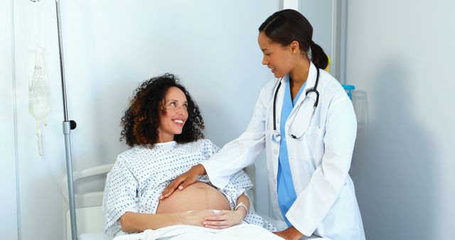 Happy Pregnant Woman Consulting with Female Doctor in Hospital Room - Download Free Stock Images Pikwizard.com