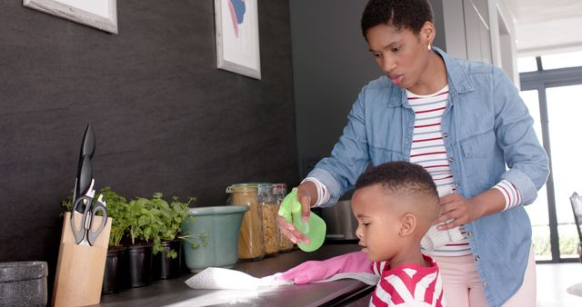 Mother and Son Cleaning Kitchen Counter Together - Download Free Stock Images Pikwizard.com