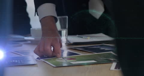 Business Meeting with Focus on Financial Charts and Online Security