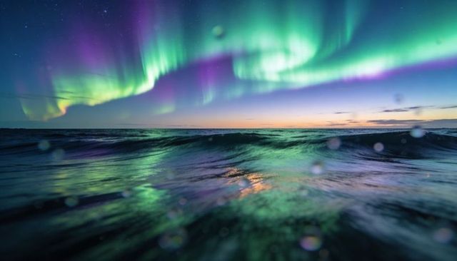 Aurora Curtains Dancing Over Ocean Twilight with Vivid Green Purple Reflections
