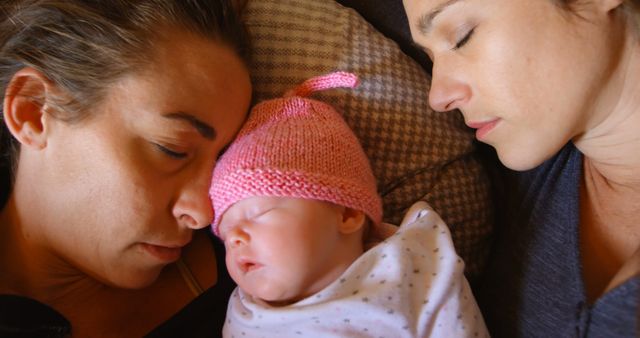 Same-Sex Parents Sleeping Peacefully with Newborn Baby - Download Free Stock Images Pikwizard.com