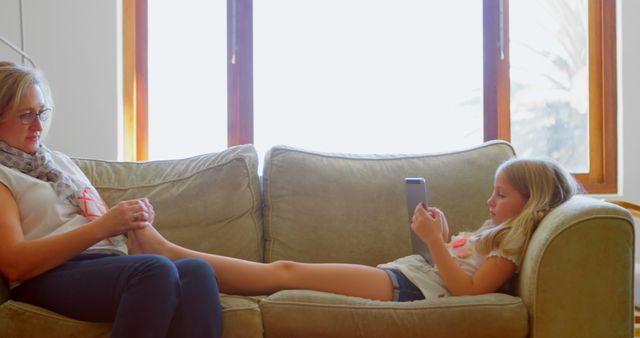 Mother and Daughter Relaxing on Couch - Download Free Stock Images Pikwizard.com