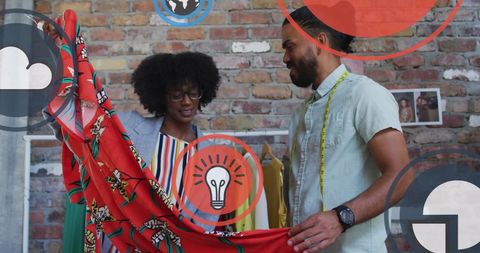 Creative Designers Collaborating in Fashion Studio Combining Art and Technology