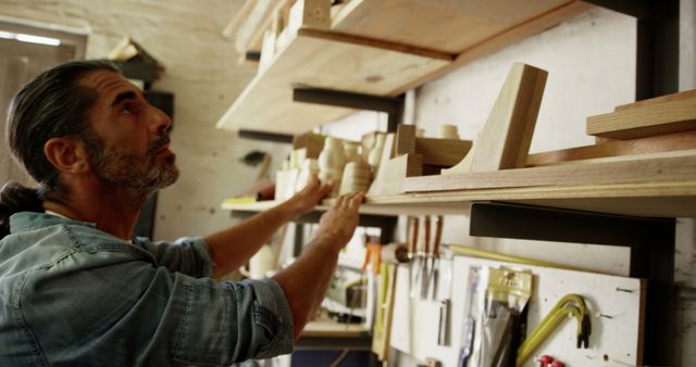 Craftsman Organizing Woodwork Projects in Workshop - Download Free Stock Images Pikwizard.com