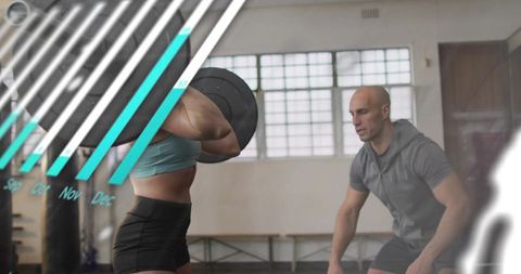 Female athlete lifting barbell front rack in gym with coach spotting strength training
