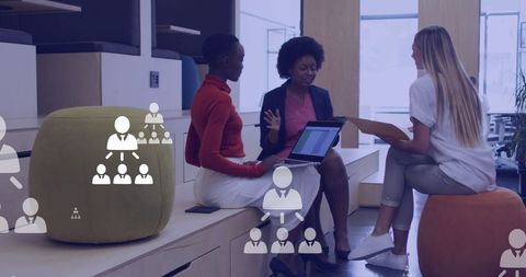 Multiracial Businesswomen Collaborating with Technology Overlays