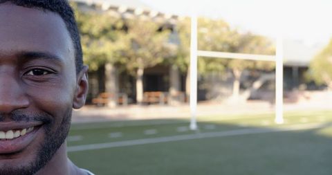 Smiling Athlete at Football Field