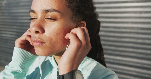 Young Woman Adjusting Earphones While Outside - Download Free Stock Images Pikwizard.com