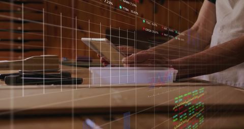 Businessman Using Tablet with Financial Data Overlay in Office