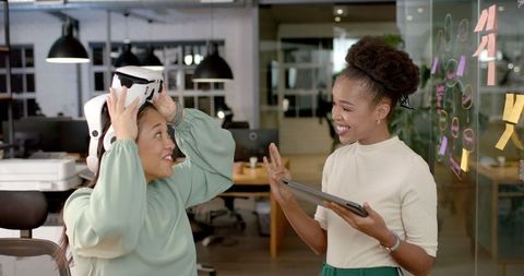 Colleagues Engaging with Virtual Reality Technology in Office