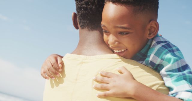 Father and Son Embracing at the Beach on Sunny Day - Download Free Stock Images Pikwizard.com