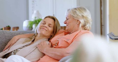Mother and Daughter Bonding on Cozy Gray Couch