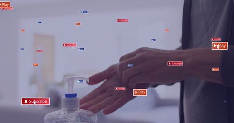 Person disinfecting hands amidst digital media icons overlay