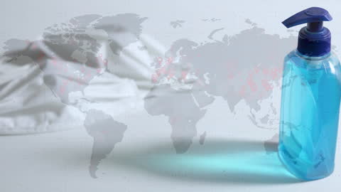 Hand Sanitizer Bottle and World Map Highlighting Pandemic Impact