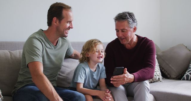 Happy Family Bonding Moment with Smartphone on Sofa - Download Free Stock Images Pikwizard.com